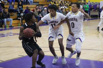 Columbia guards Dante Brown (11) and Jordan Smith (0) pressure Buchholz in the back court during Tuesday night’s game. (JORDAN KROEGER/Lake City Reporter)