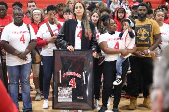 Samira Conley, the wife of Tramaine Conley, holds back tears after being presented with his Fort White jersey prior to Thursday’s game against Bell. (JORDAN KROEGER/Lake City Reporter)