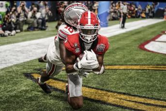 Georgia wide receiver Adonai Mitchell (5) makes a touchdown catch against Ohio State cornerback Denzel Burke (10) during the second half of the Peach Bowl NCAA college football semifinal playoff game, Saturday, Dec. 31, 2022, in Atlanta. Brynn Anderson/Associated Press)