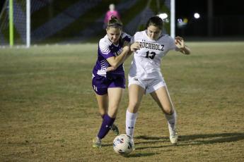 Columbia’s Sydney Rivas (left) battles for control of the ball with Buchholz’s Zoe Torres during Tuesday night’s game at Tiger Stadium. Torres scored a goal for her side in the 4-1 CHS loss. (BRENT KUYKENDALL/Special to the Reporter)