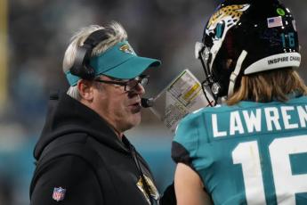 Jacksonville Jaguars head coach Doug Pederson (left) speaks to Jacksonville Jaguars quarterback Trevor Lawrence on the sidelines during last Saturday's wild-card playoff game against the Los Angeles Chargers in Jacksonville. (CHRIS O'MEARA/Associated Press)
