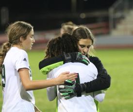 Suwannee goalkeeper Layla Merola hugs and consoles Alaira Handy following the Bulldogs’ 2-1 loss to Santa Fe in the District 2-4A championship on Monday night. (JORDAN KROEGER/Lake City Reporter)