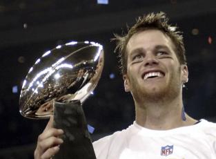 New England Patriots quarterback Tom Brady holds the Vince Lombardi Trophy after the Patriots beat the Carolina Panthers 32-29 in Super Bowl 38 on Feb. 1, 2004, in Houston. (AP FILE)