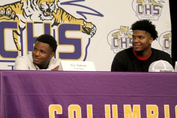 Columbia receiver Tra' Tolliver (left) signed his letter of intent with Iowa Central Community College on Wednesday, while defensive end Rashod Bradley (right) signed with East Mississippi Community College. (JAMIE WACHTER/Lake City Reporter)