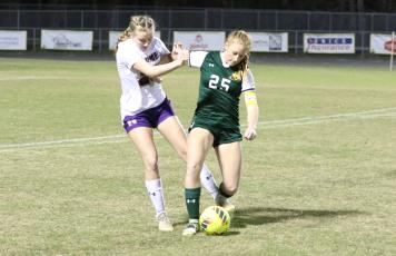 Lecanto’s Mallory Mushlit fights off Columbia’s Kyndall Norris to corral possession of the ball during Tuesday’s Region 1-5A quarterfinal. (MORGAN MCMULLEN/Lake City Reporter)