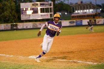 Columbia shortstop Brayden Thomas turns off third base on his way to home plate to score a run against Valdosta on Thursday night. (BRENT KUYKENDALL/Lake City Reporter)