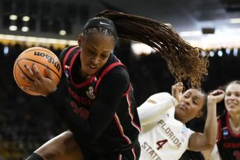 Georgia forward Jordan Isaacs grabs a rebound in front of Florida State guard Sara Bejedi during a first-round game in the NCAA tournament on Friday in Iowa City, Iowa. (CHARLIE NEIBERGALL/Associated Press)