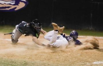 Suwannee catcher Jace Moran tags out Columbia second baseman Trayce McKenzie at home plate on Thursday. (BRENT KUYKENDALL/Lake City Reporter)
