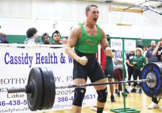 Suwannee’s Sam Wainwright celebrates after completing his clean and jerk during he Bulldog Invitational on Friday. (PAUL BUCHANAN/Special to the Reporter)