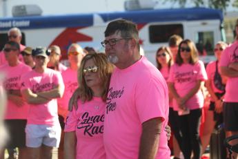 Grace Duncan’s parents, Burt and Cissy, listen during a prayer prior to the start of last year’s Grace’s Race 5K run/walk. The fourth annual event, which is held in Duncan’s memory, is set for Saturday. (FILE)