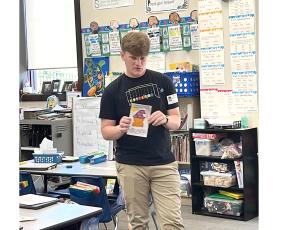 Jacob Sheldon reads his book, ‘I Think My Cat’s A Wizard’ to students at Belmont Academy. (COURTESY)