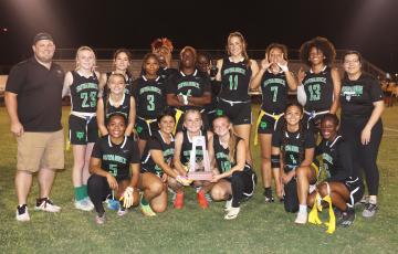 Suwannee’s flag football team poses with the District 3-1A championship trophy after defeating Columbia 6-0 on Wednesday. (PAUL BUCHANAN/Special to the Reporter)