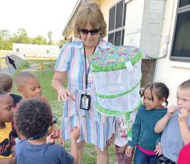 Summers Elementary School VPK teacher Karen McDonald works with students outside of the school. The Summers VPK program earned a perfect state score. (COURTESY))