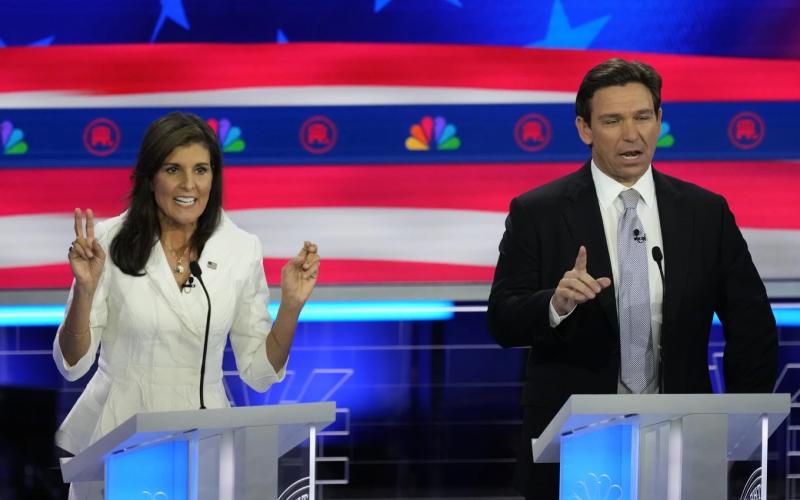 Former U.N. Ambassador Nikki Haley and Florida Gov. Ron DeSantis talk during a Republican presidential primary debate on Wednesday at the Adrienne Arsht Center for the Performing Arts of Miami-Dade County in Miami. (REBECCA BLACKWELL/Associated Press)