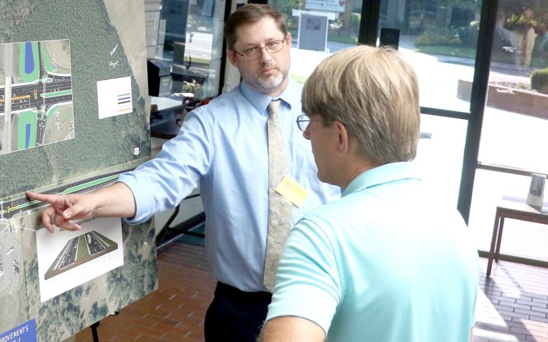 Michael Brock, an engineer with the Florida Department of Transportation, discusses the Interstate 10 and U.S. Highway 129 interchange improvements with Brent Baris during an open house Thursday at Live Oak City Hall. (MORGAN MCMULLEN/Lake City Reporter)