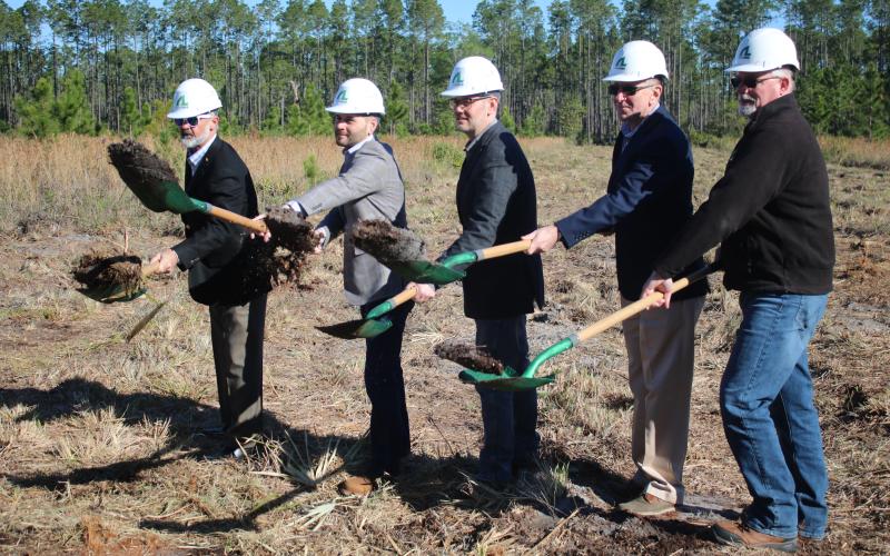 AgroLiquid adminstrators David Gilliam (from left), Gerrit Bancroft, Nick Bancroft, Alan Kennedy and Todd Cressman toss dirt from their shovels during a March groundbreaking ceremony for the company’s new plant at the North Florida Mega Industrial Park. (FILE)