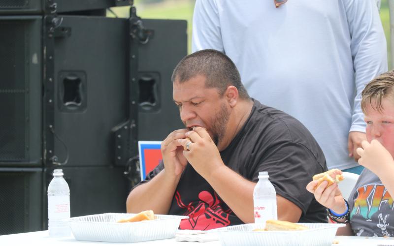 Steven Flores takes part in the hot dog eating contest during the Rotary Club of Lake City’s Independence Day celebration last year at Wilson Park. The hot dog eating contest will be back as part of this year’s event. (FILE)